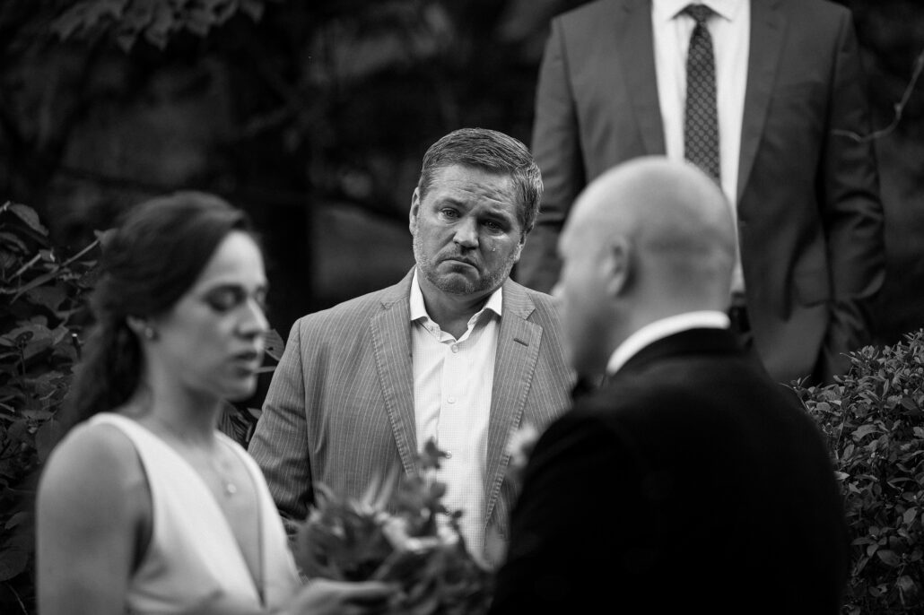 emotional wedding moment with Japanese garden view. the bride's brother crying at beautiful vows.