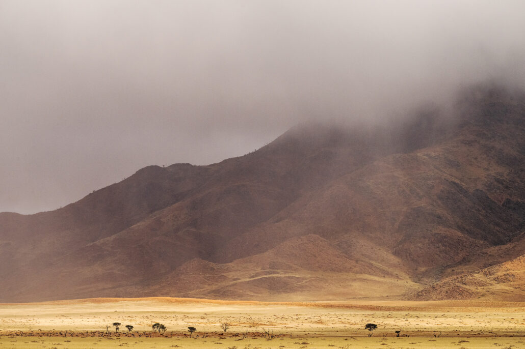 D707 under stormy skies - a surreal moment of contrast between rain, dust, and solitude.