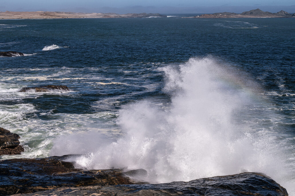 Crashing Atlantic Ocean waves under dramatic skies at Diaz Point, Namibia.