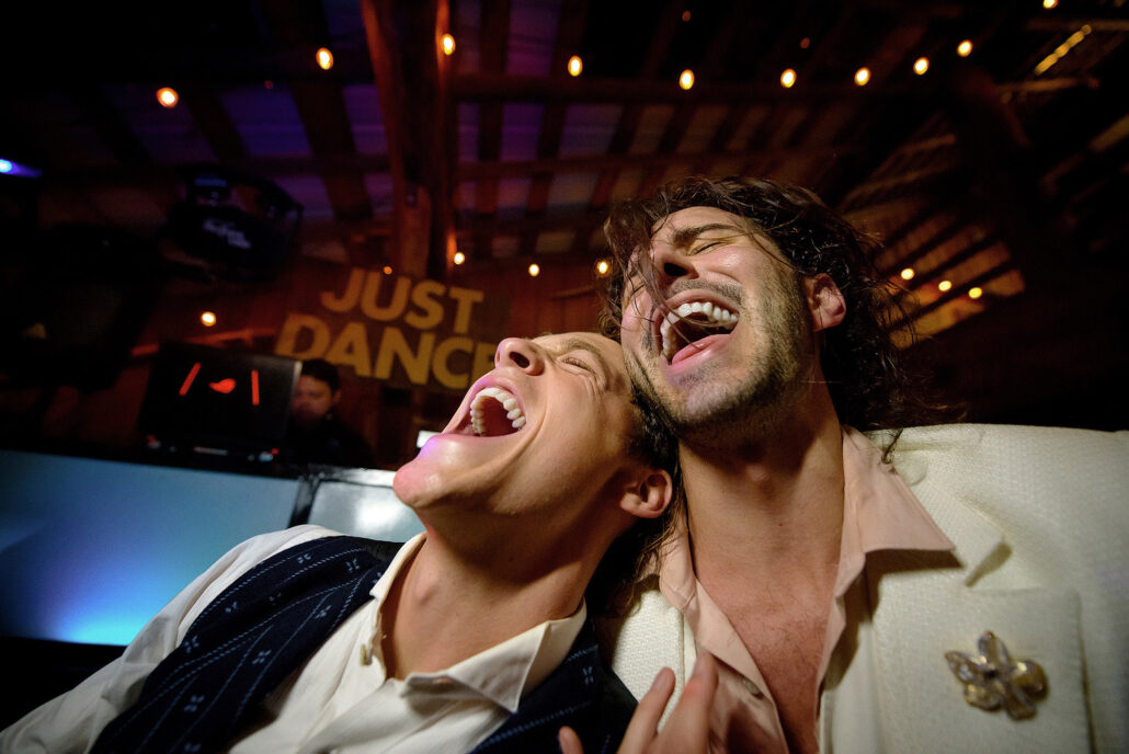 Couple singing together on the dance floor during their wedding celebration, edited with AI editing software for photographers for bold, vibrant tones.