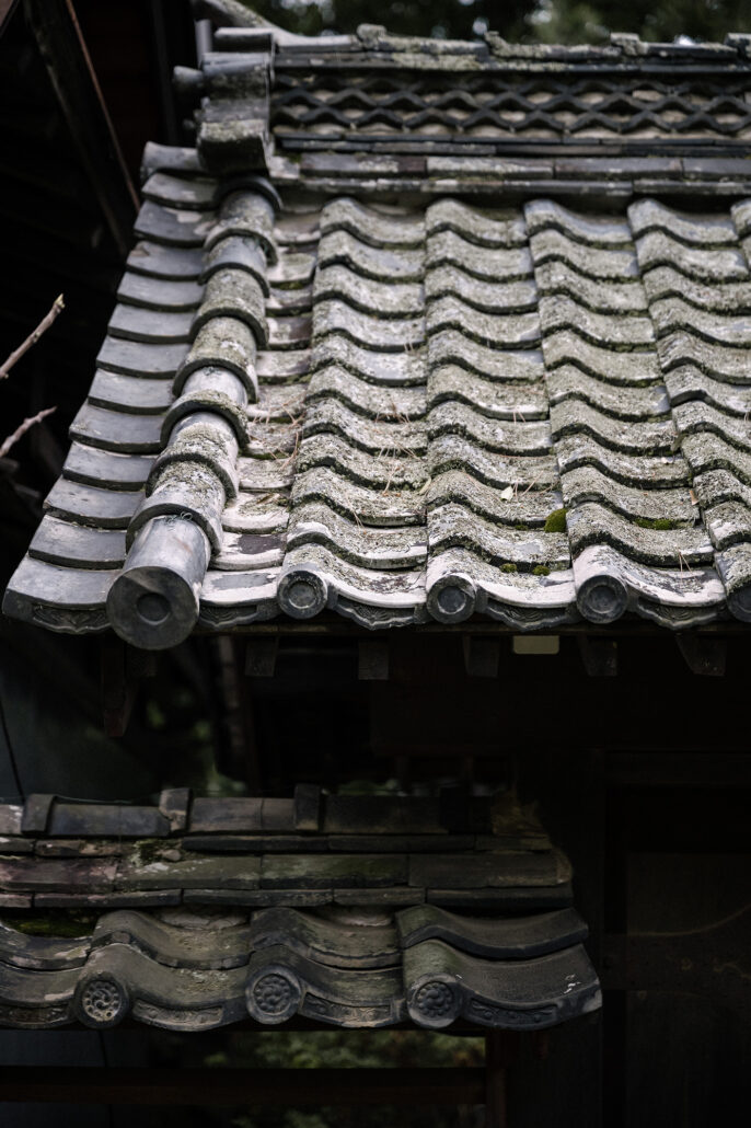 Weathered clay roof tiles on the old villa in Matsumoto where the couple got ready for their cherry blossom wedding in Nagano.