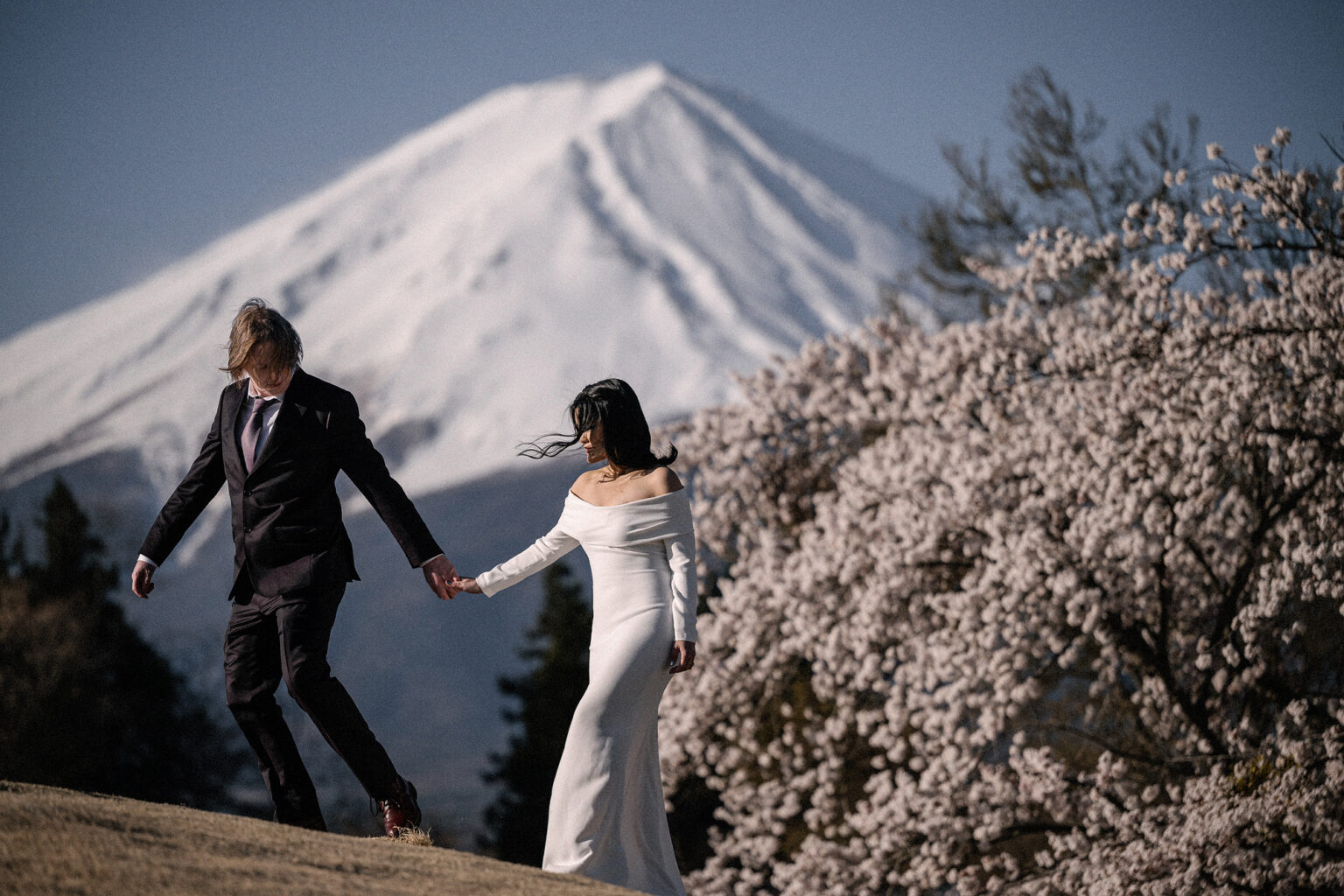 Bride and groom getting married at Mt Fuji in cherry Blossom season.