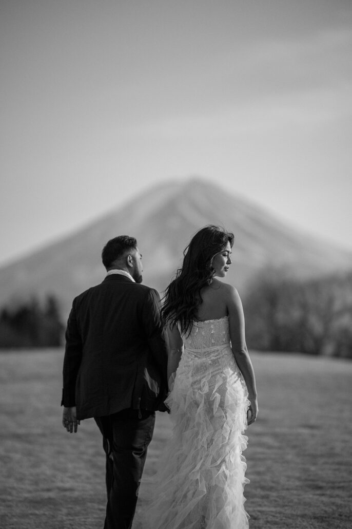 Final art wedding image of a couple in a designer dress with Mt Fuji in the background.
