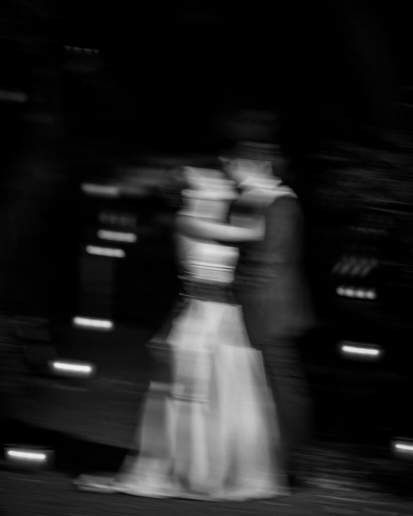 In black and white, the bride and groom blur into motion as they dance close in the dark on their wedding night at Jinya Ryokan.