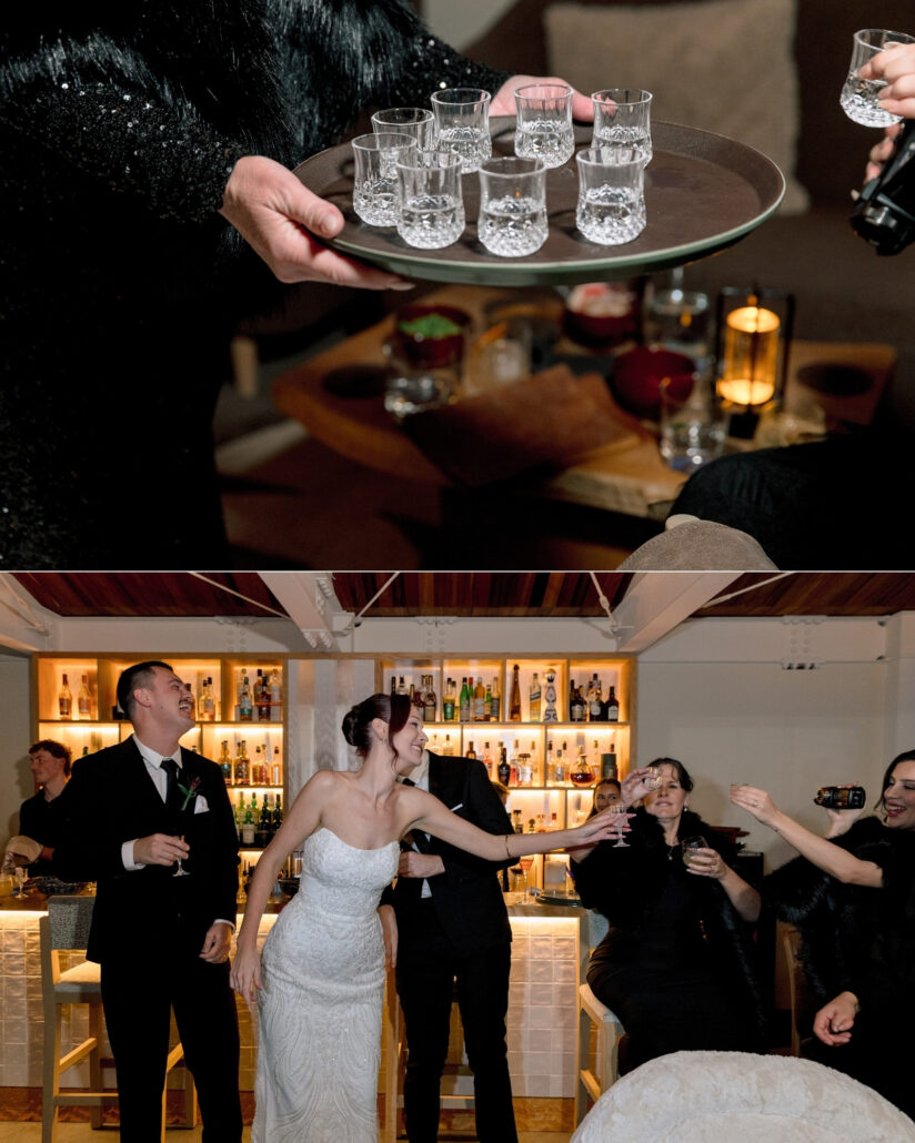 A tray of crystal shot glasses passes through the bar, and the bride and groom laugh with guests raising their glasses at cocktail hour in Hakuba.