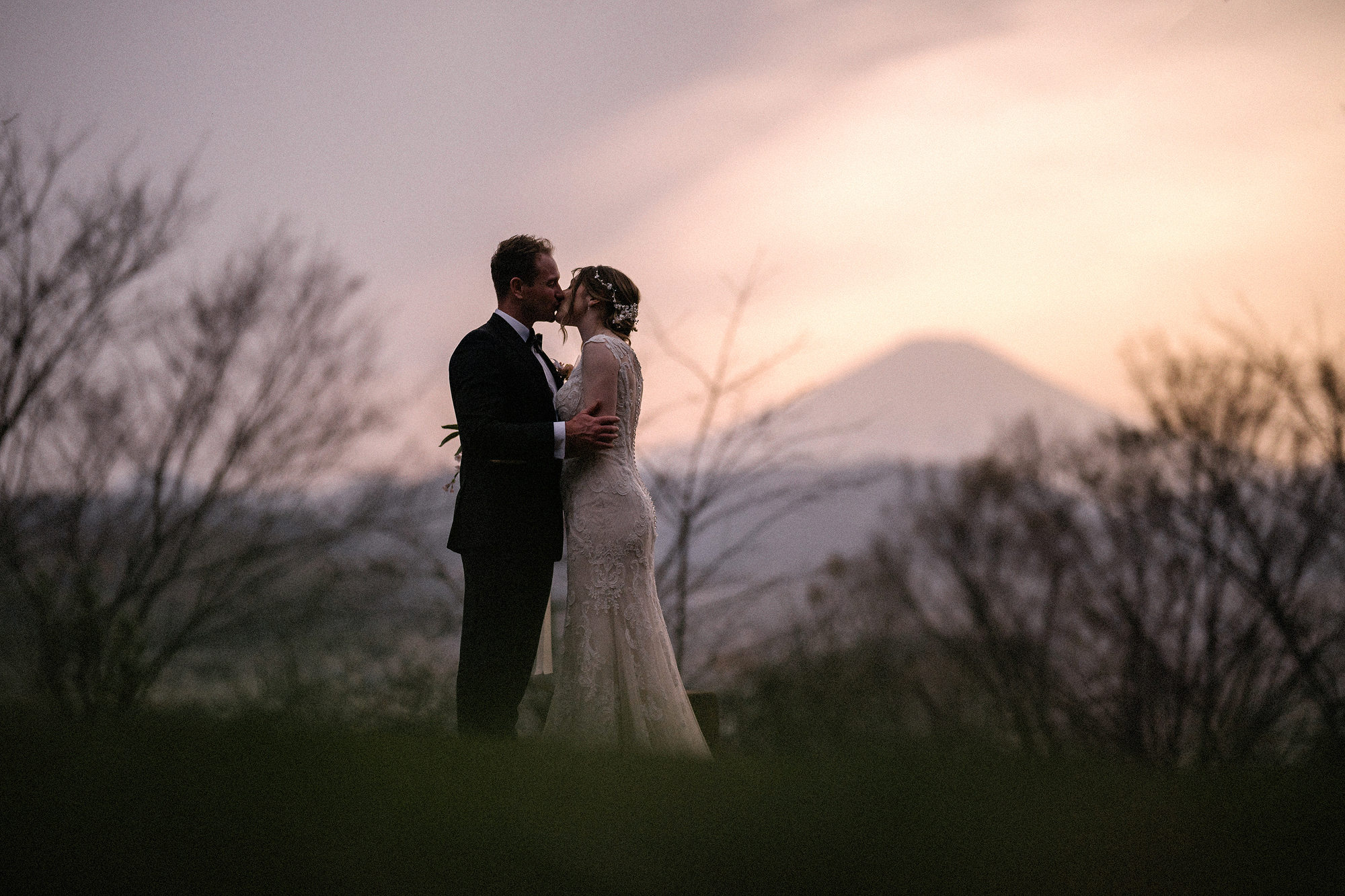 A couple standing together in an open landscape during an elopement ceremony with no audience but the world around them