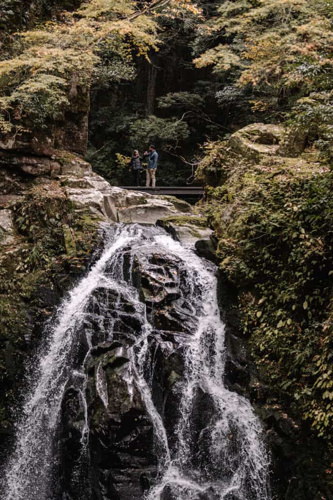 The couple dance on a footbridge above a waterfall at Akame 48 Falls in Mie, just over the Nara border, on the morning of their wedding.
