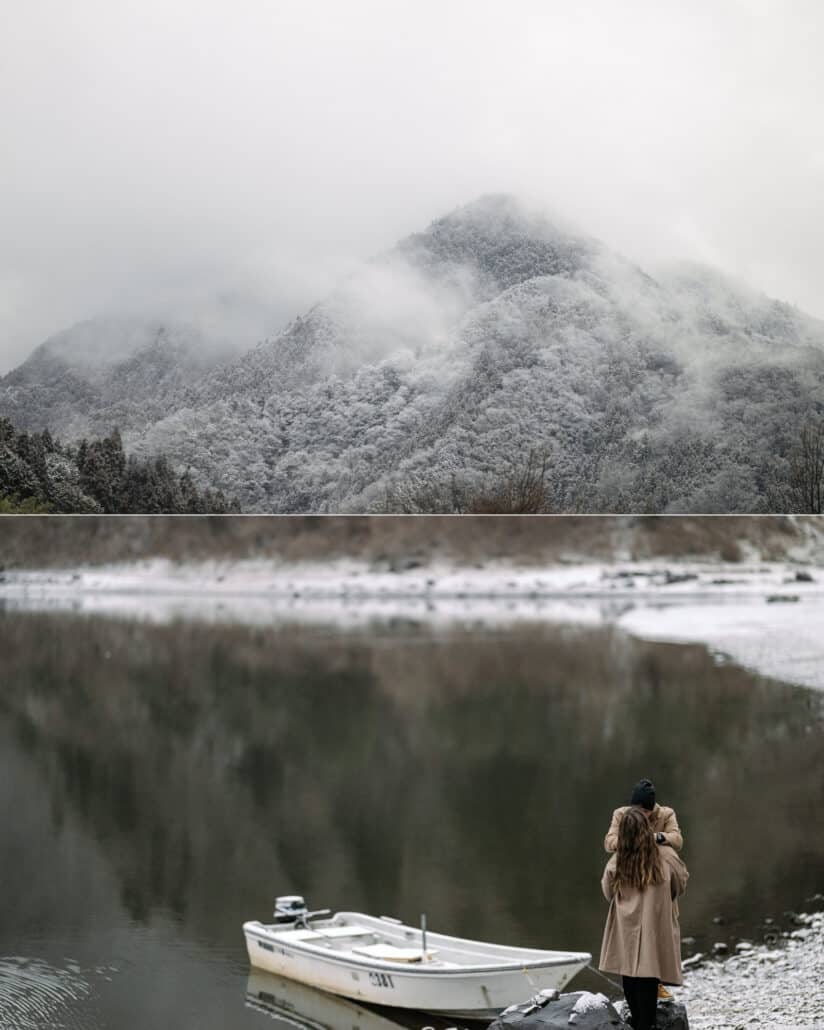 A snow-dusted peak wrapped in cloud, and she stands beside a small white rowboat on the snowy shore of Lake Shoji.