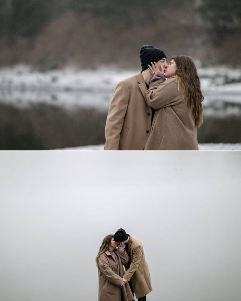 The couple kiss on the shore in falling snow, and hold each other small against the white of the whiteout sky.