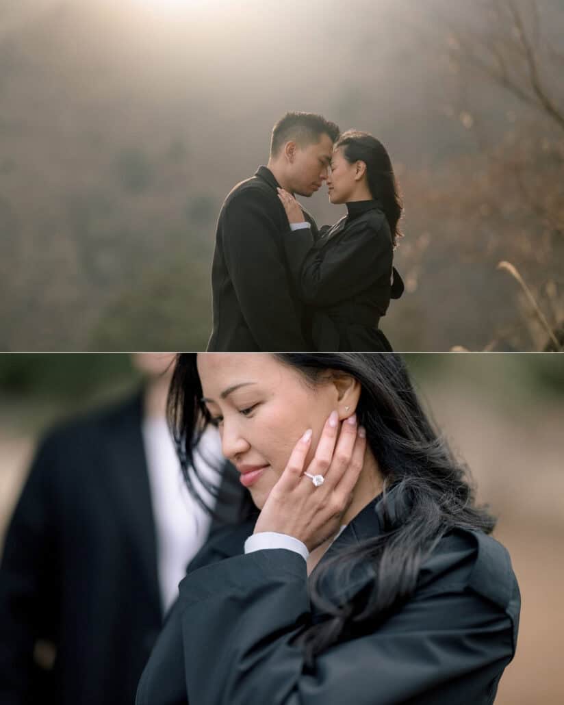 The couple close together in soft golden haze, and she smiles with her engagement ring hand resting against her cheek.