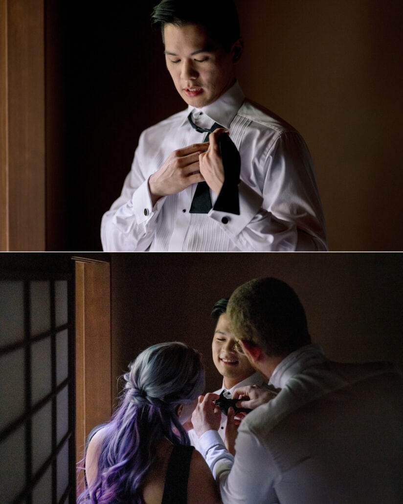 The groom holds the loose ends of his untied bow tie, then two friends work on it by the shoji, the bow tie story their Japan wedding film tells.