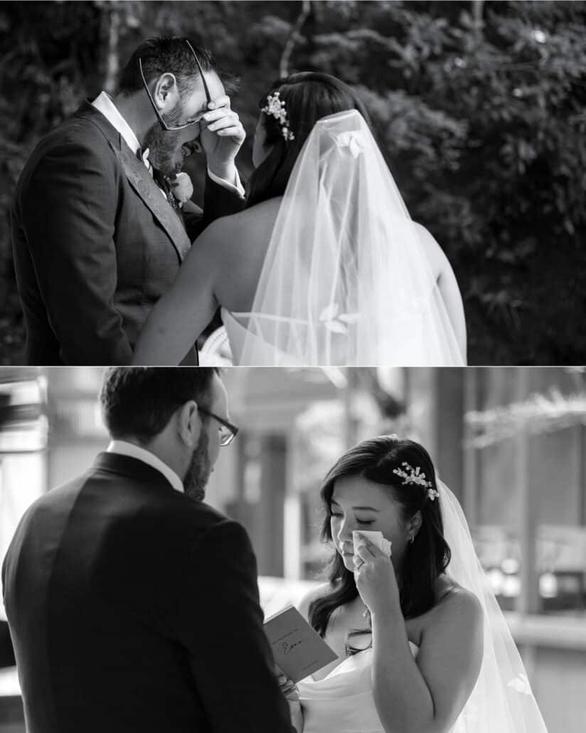 The groom lifts his glasses to wipe his eyes and the bride dabs hers with a tissue, vow book in hand, during their private vows at Asaba ryokan.