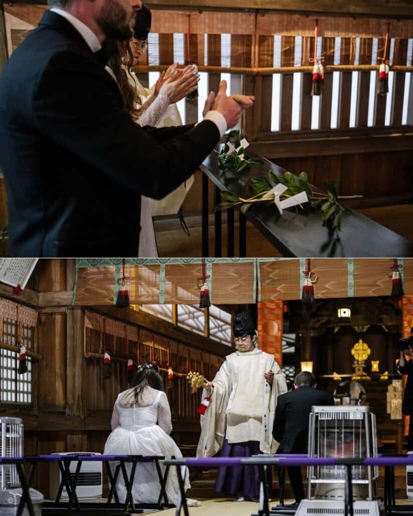The couple clap before sakaki branches laid on the offering table, then sit as a Shinto priest shakes golden bells toward them in the shrine hall.