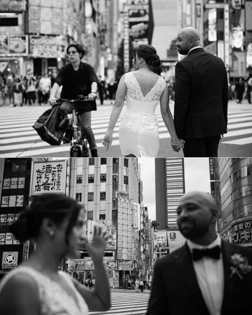 In black and white, a cyclist rides past as the couple cross a Shinjuku street hand in hand, and share a laugh among the signs.