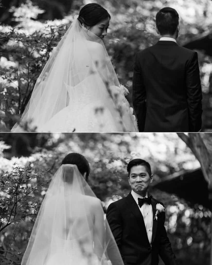 In black and white, the bride steps up behind the groom in the garden at Jinya, then he turns to see her at their first look, lips pressed tight.