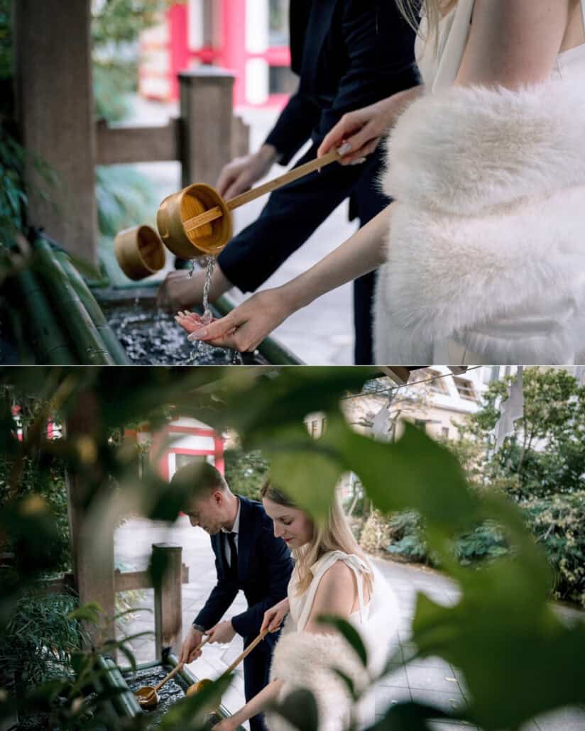 At a shrine water basin in Tokyo the couple rinse their hands with wooden ladles, up close and through the leaves, before their elopement in Japan.
