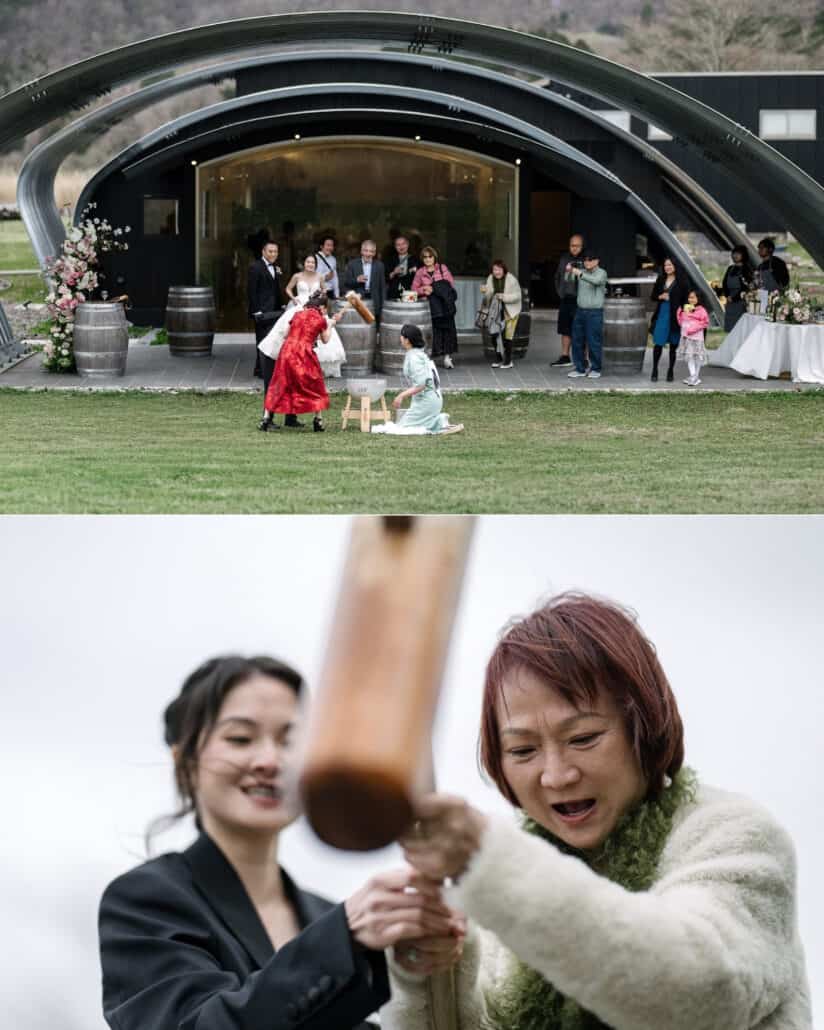 Guests pound mochi on the lawn among wine barrels in front of the arched Fujisan Winery building, then two guests share the wooden mallet.