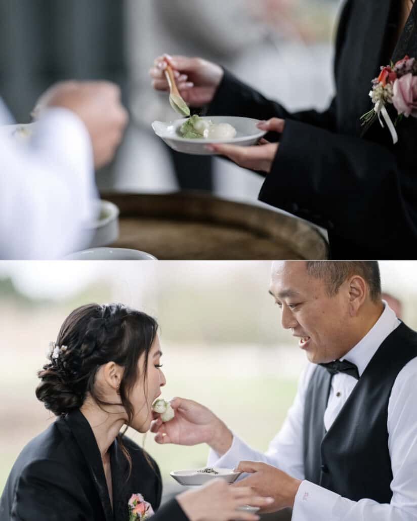 A plate of mochi is served beside a wine barrel at the reception at Fujisan Winery, and the groom in his waistcoat feeds the bride a piece.