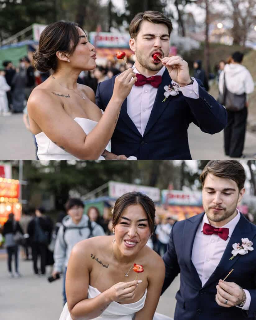 The bride and groom share candied strawberries at the Hirosaki cherry blossom festival, laughing among the stalls.