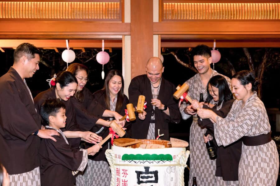 Mallets come down on the sake barrel as the families break it open together at a wedding welcome dinner in Japan.