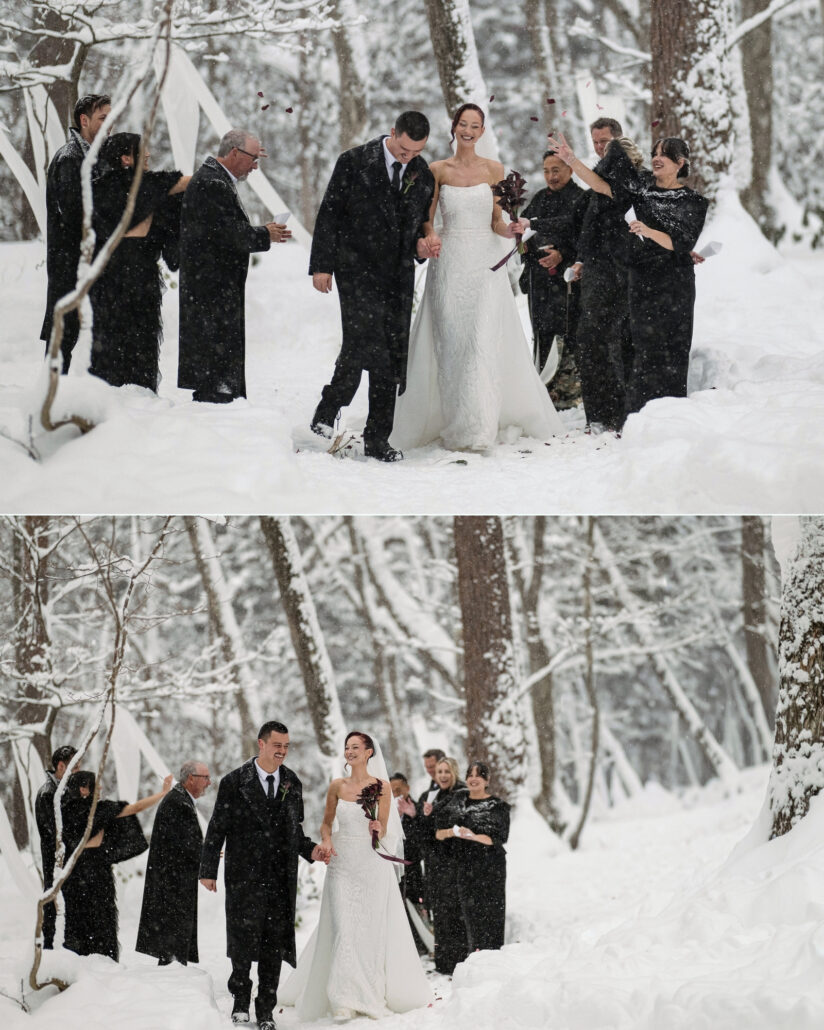 The bride and groom walk arm in arm through the snowy forest after their ceremony, laughing with their wedding party.
