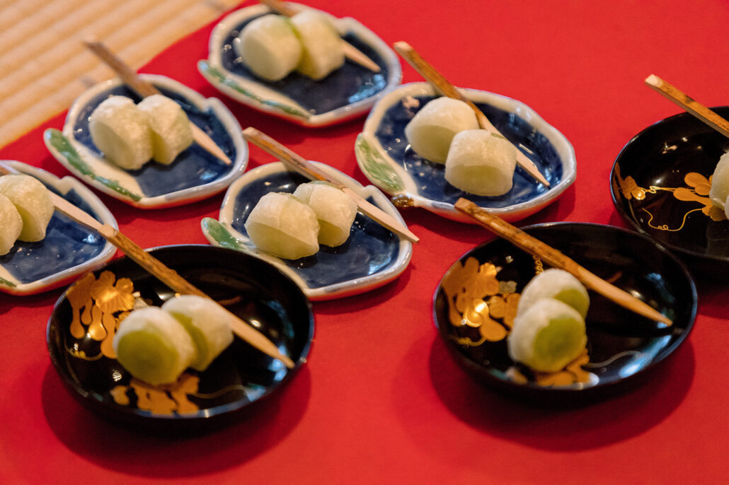 Japanese sweets on blue-patterned plates and black lacquer dishes laid out for wedding guests, the kind of small pleasure that gives people ikigai