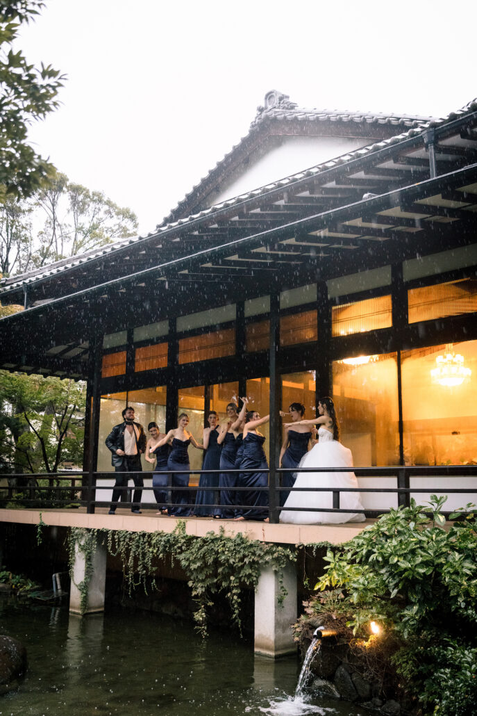 The pavilion roof and lit veranda at Jinya, the wedding party small on the walkway.