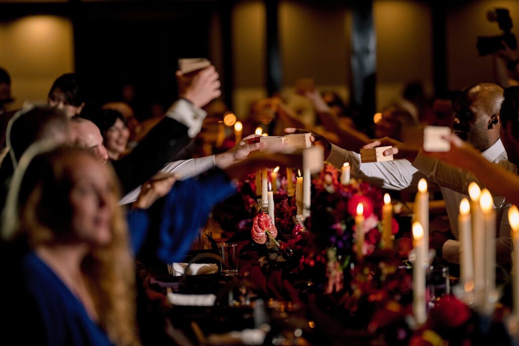 Guests raise wooden masu cups of sake in a toast at the reception.