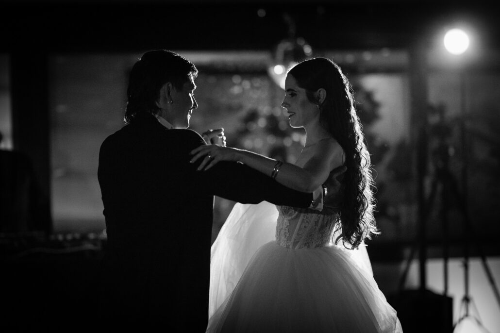 In black and white, the couple in their waltz hold.