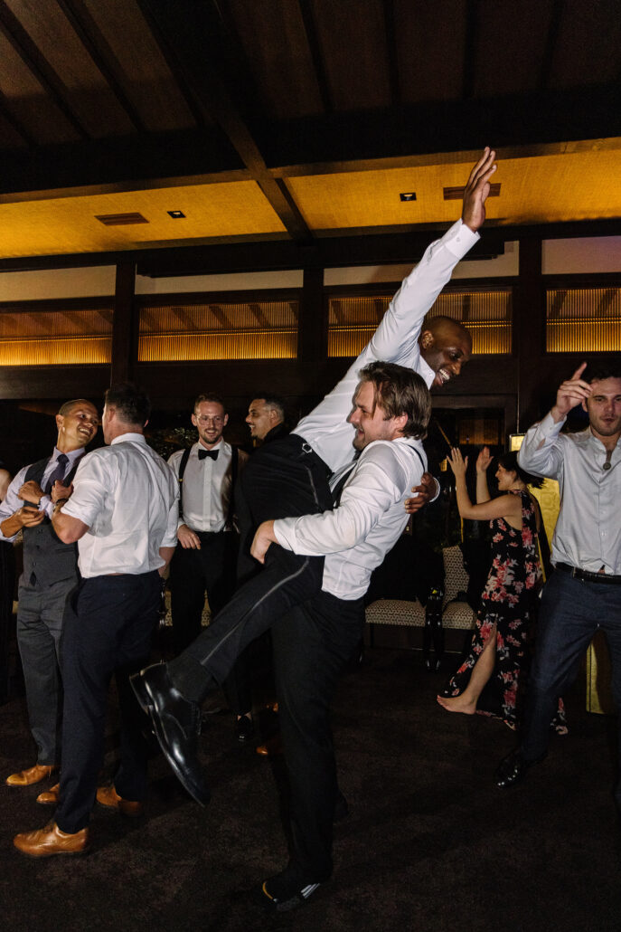A guest leaps into a high kick on the dance floor.