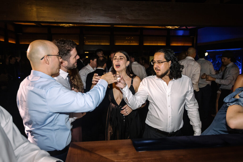 Guests take shots together at the bar.