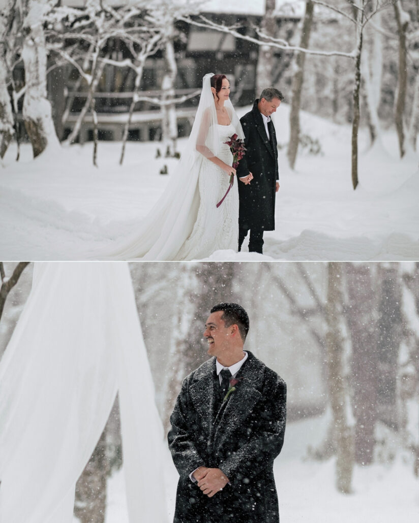 The bride walks hand in hand with an older man in a dark overcoat, and the groom laughs in falling snow at a winter wedding in Hakuba.