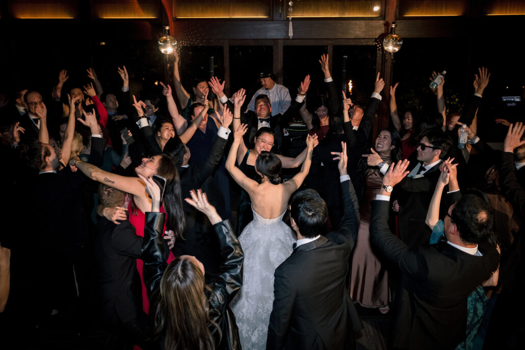 Hands go up all over the dance floor as the bride dances in the middle of the crowd.